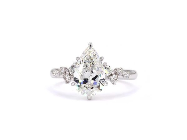 Pear cut ring with diamond studded pave band