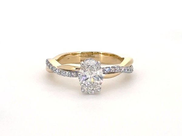Oval ring with hidden halo and diamond studded twisted band