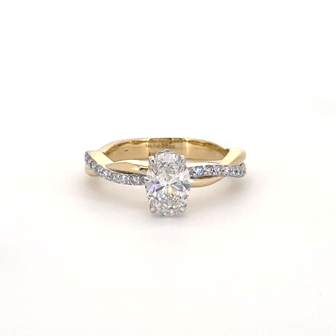 Oval ring with hidden halo and diamond studded twisted band