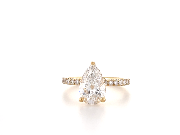 Pear cut ring with hidden halo and diamond band